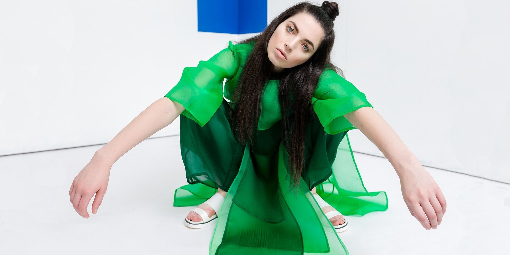 Woman wearing stylish green leggings showcasing the 2022 green color trend