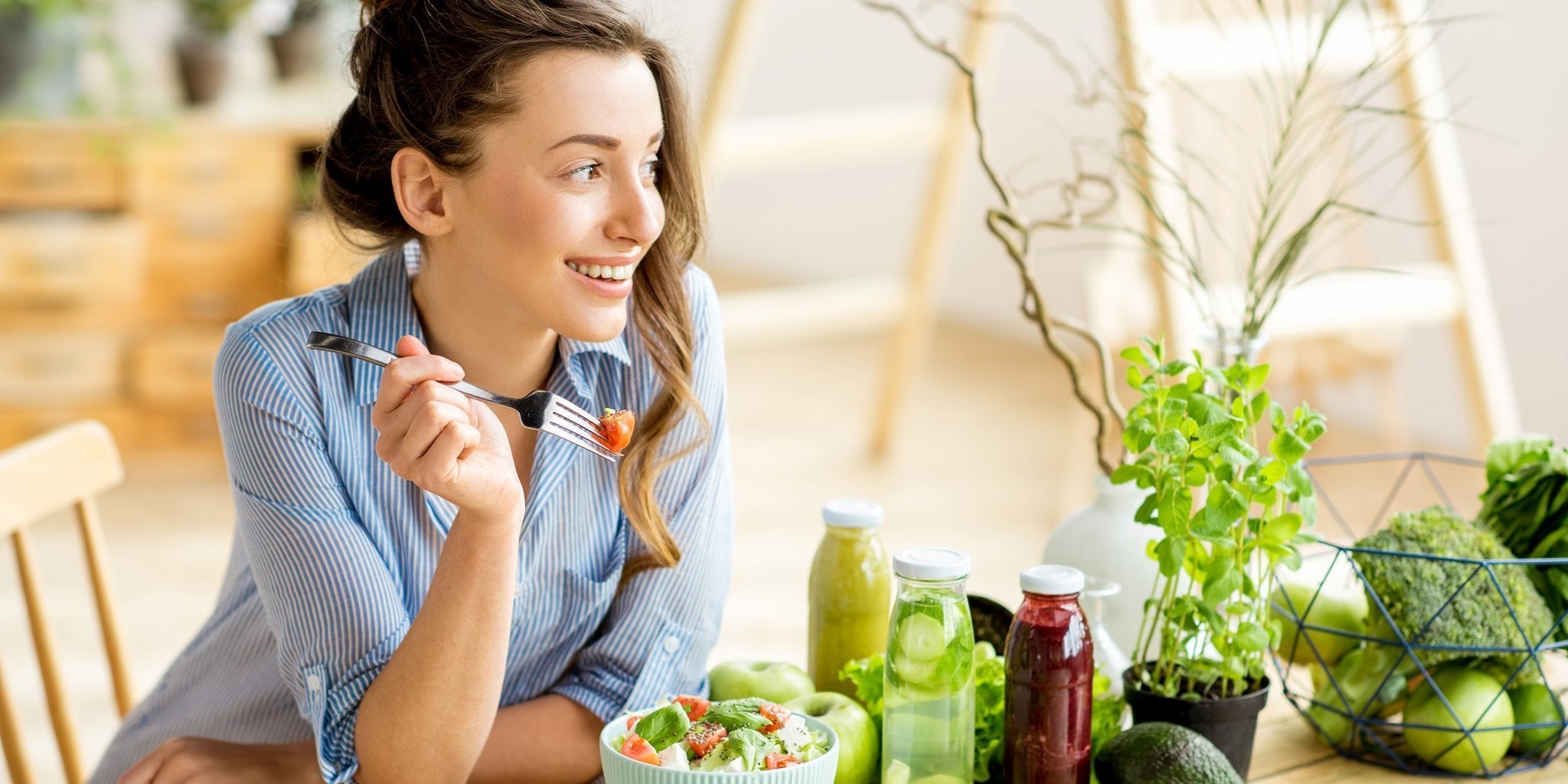 Busy woman drinks water and eats fruit at breakfast to stay healthy