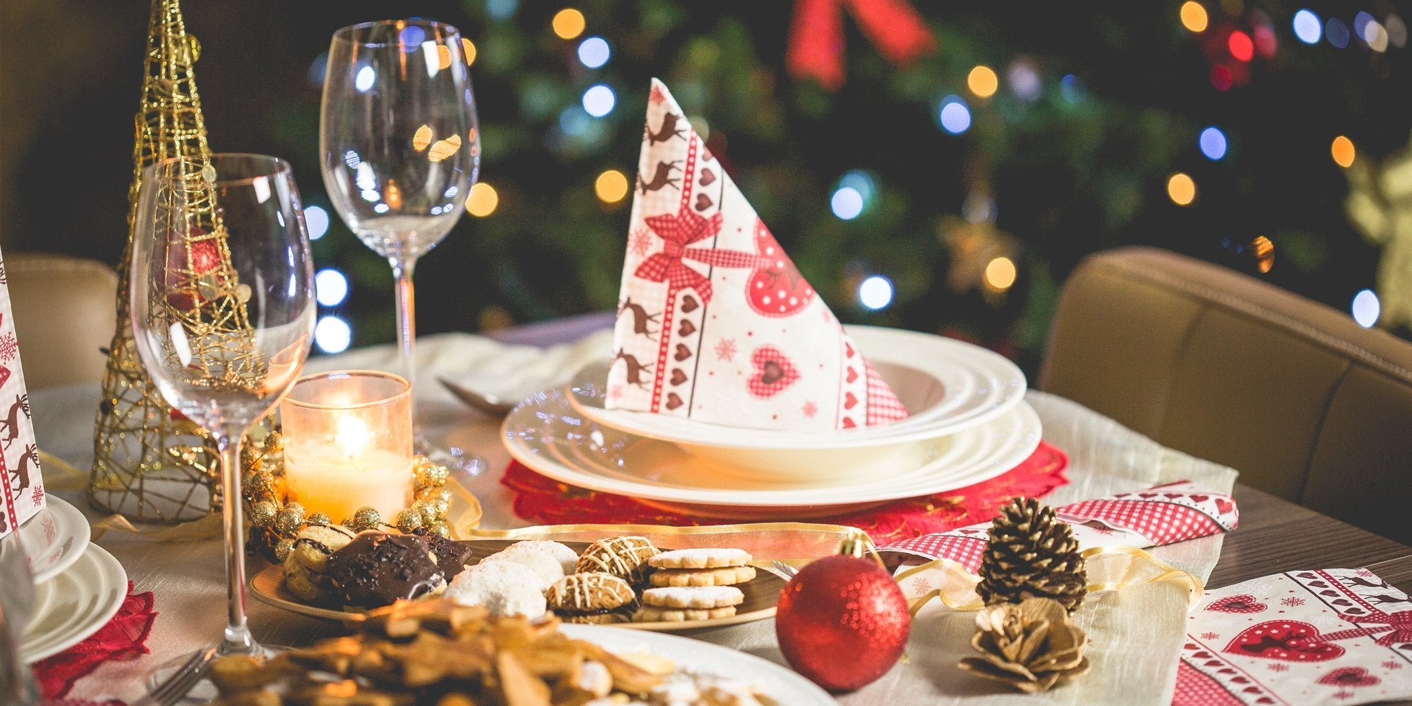 Festive holiday table with fruits, vegetables, and Christmas decorations