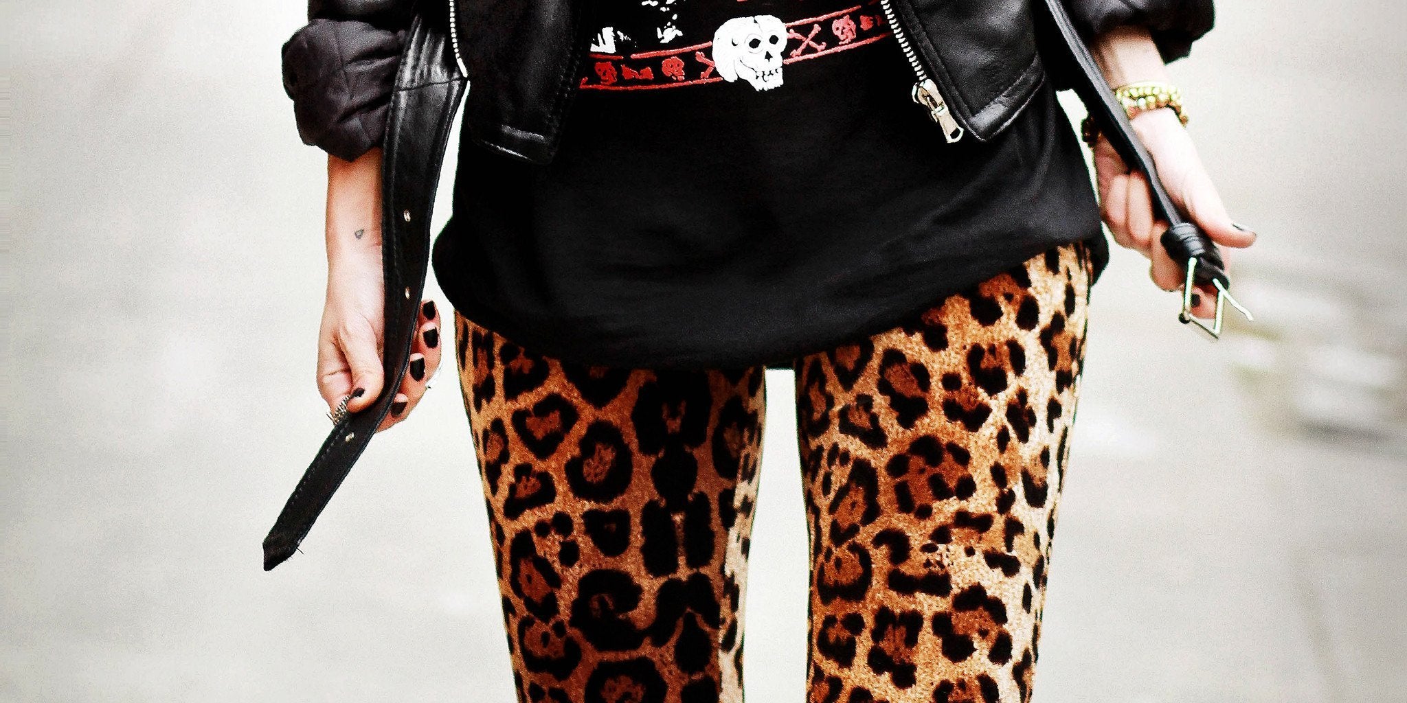 Woman wearing anaconda snake skin print leggings and striped backpack