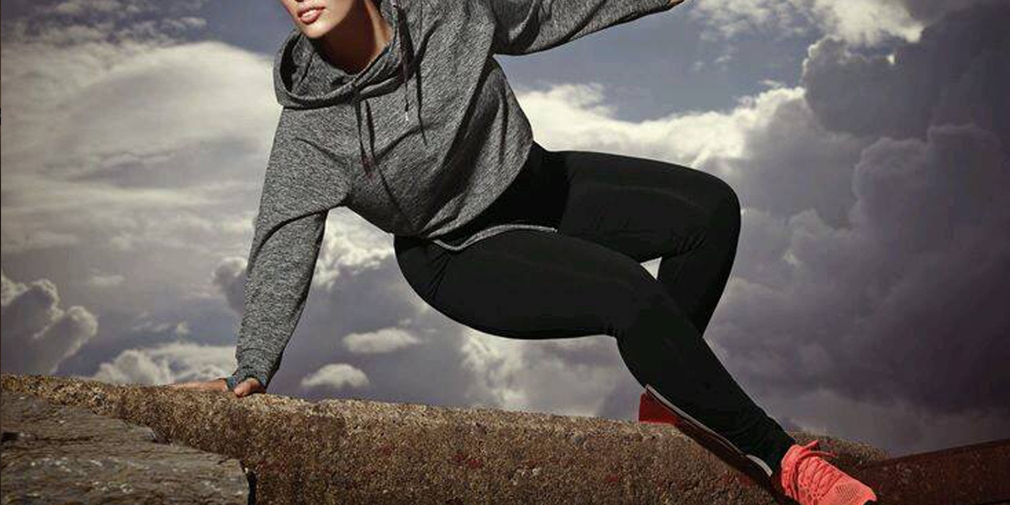 Curvy woman confidently exercising in vibrant, patterned plus size leggings at the gym