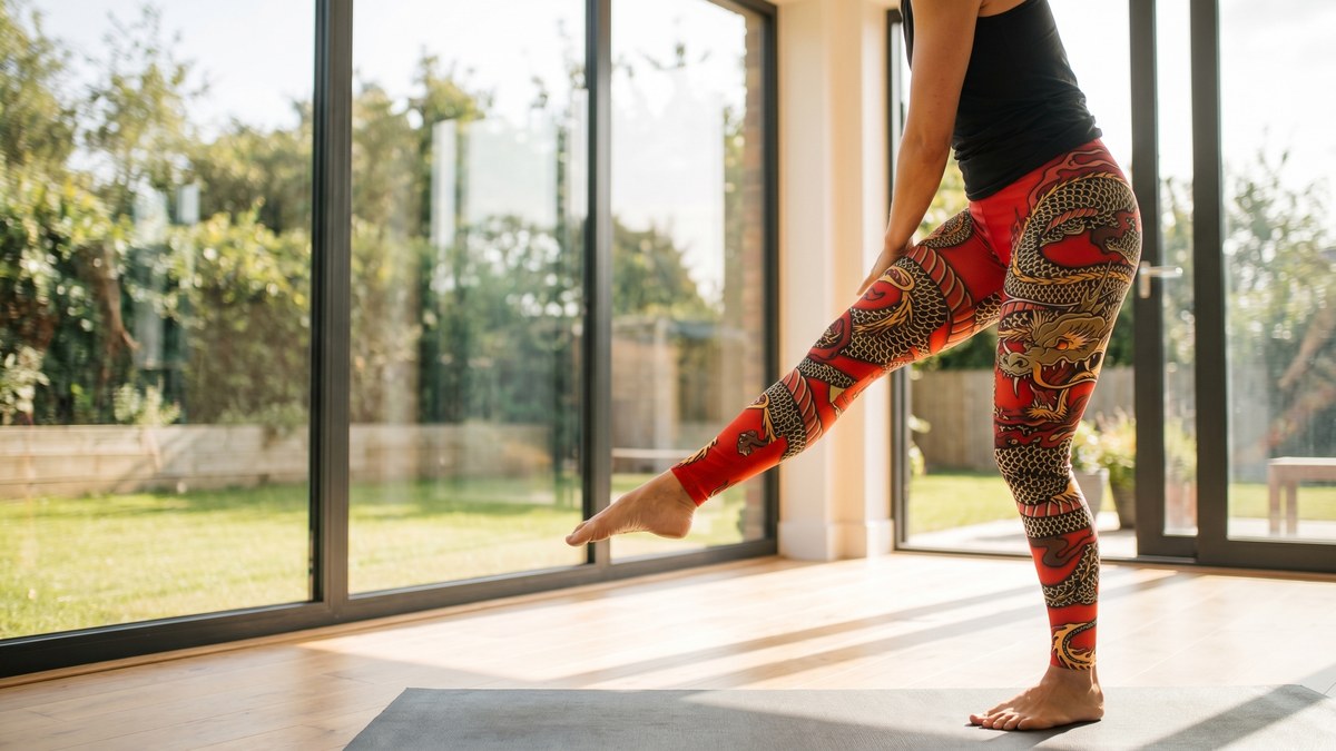 Woman in dragon print leggings strikes a pose, showcasing bold workout style