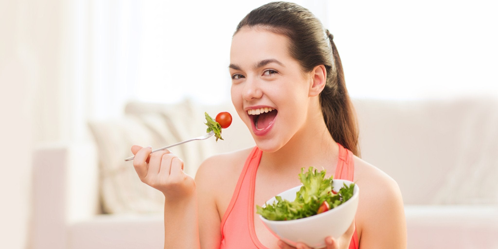 Teenager eating a balanced meal of fruits, vegetables, and protein