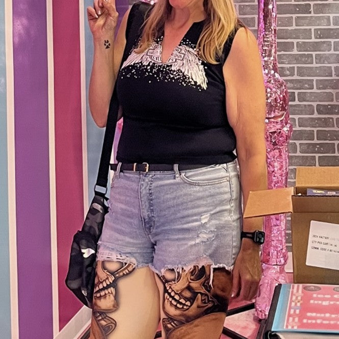 Woman in vibrant printed leggings doing squats at the gym for leg workout