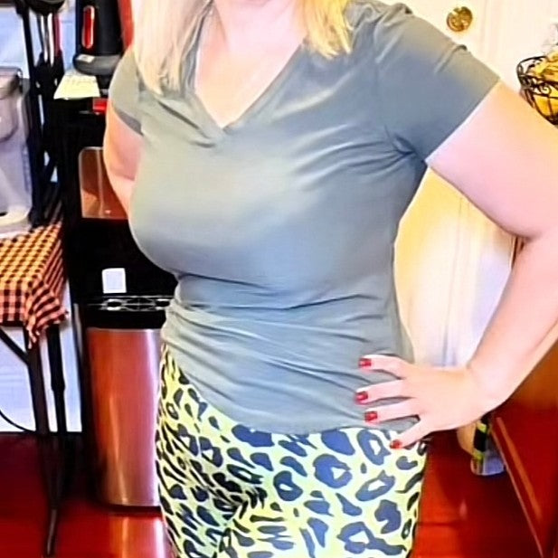 Woman in vibrant printed leggings and top in an urban setting