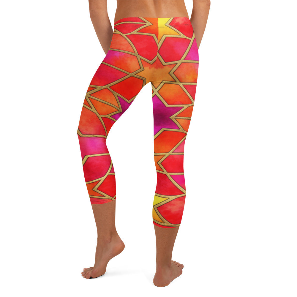 Close-up of fiery red, orange, and gold Arabic Fire Opal print on GearBunch Capri Leggings. Geometric pattern with vibrant colours.