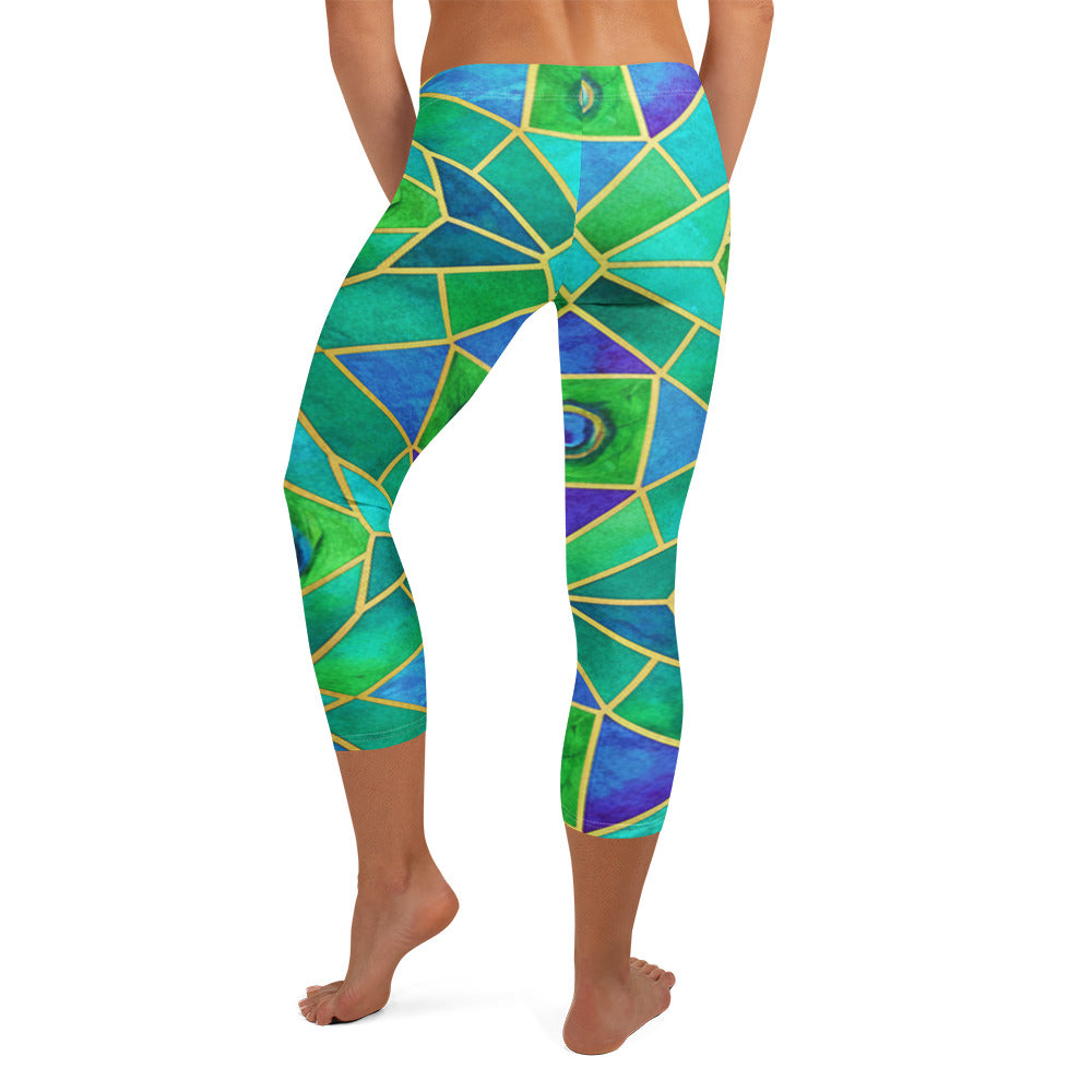 Arabic Watercolour Peacock Plume Capri Leggings from GearBunch featuring geometric designs in vibrant blues, greens, and gold.