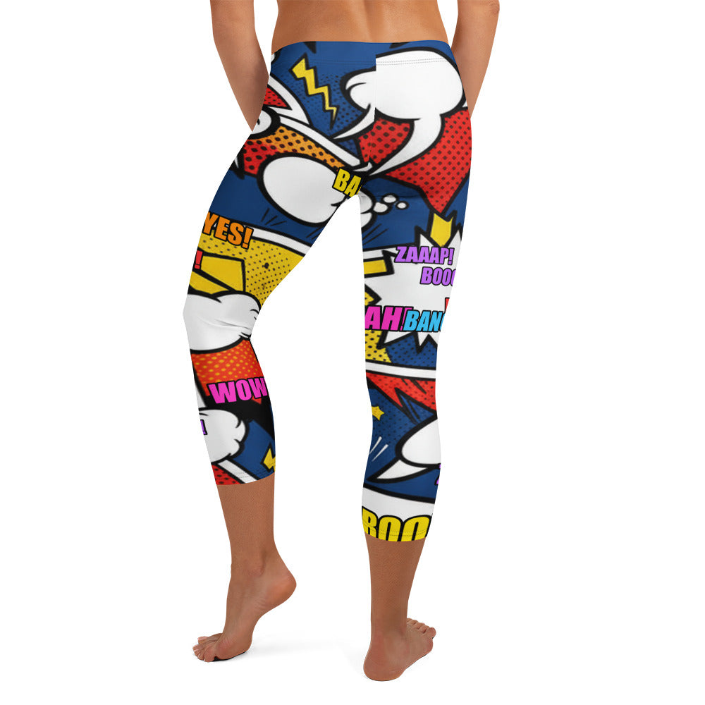 Bold comic strip explosion print GearBunch Capri Leggings featuring electric yellow, deep navy, red and orange.