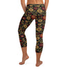 Lush gold, red, and burgundy floral print GearBunch Capri Leggings with a dark shimmering background.
