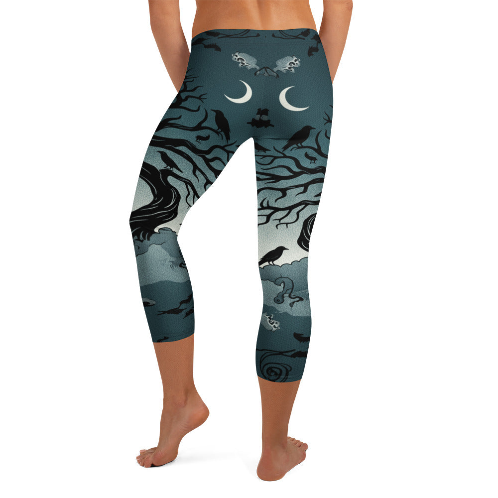 Detailed all-over print of a haunted forest on GearBunch Capri Leggings, midnight teal, fog white, and black.