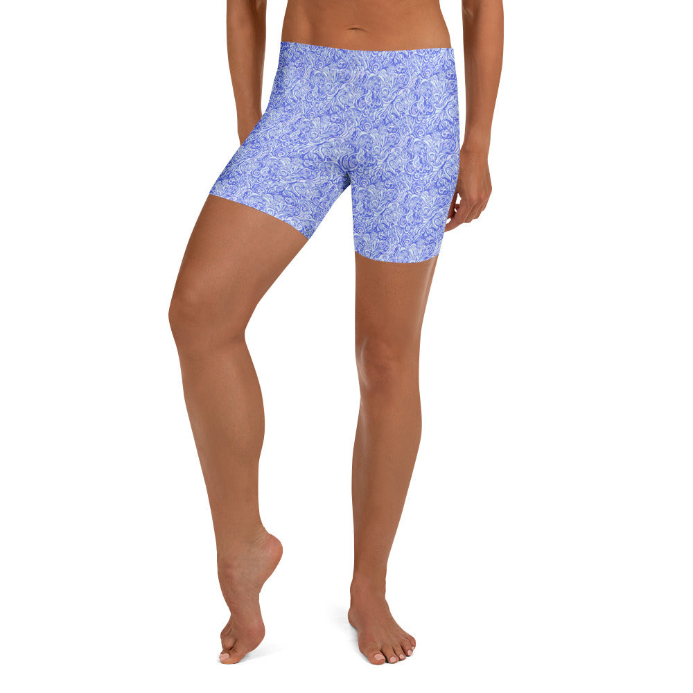 Active woman in Kay Nielsen Fairytale Gear Up Shorts, showcasing sky blue, lavender, and white pattern. GearBunch Shorts.