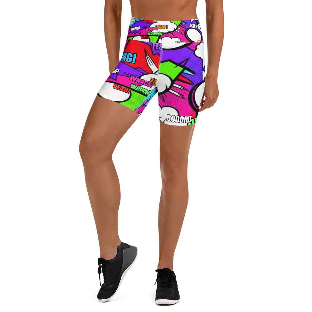 Close-up of a woman wearing Comic Pop Neon Pink Yoga Shorts from GearBunch, showcasing the vibrant comic book-inspired all-over print.